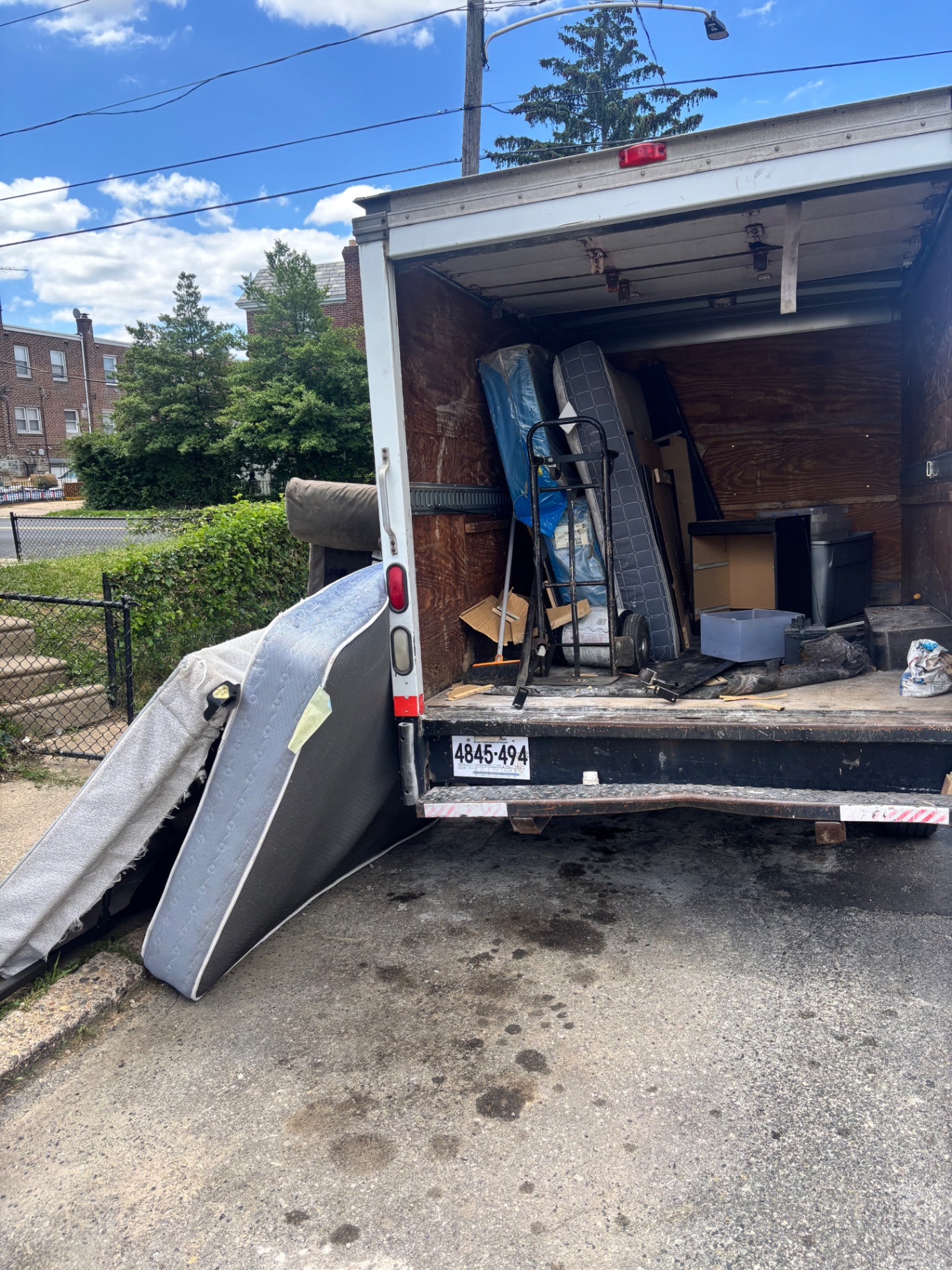 B.L.O.O.M. Entity box truck loaded with mattresses and household junk ready for disposal