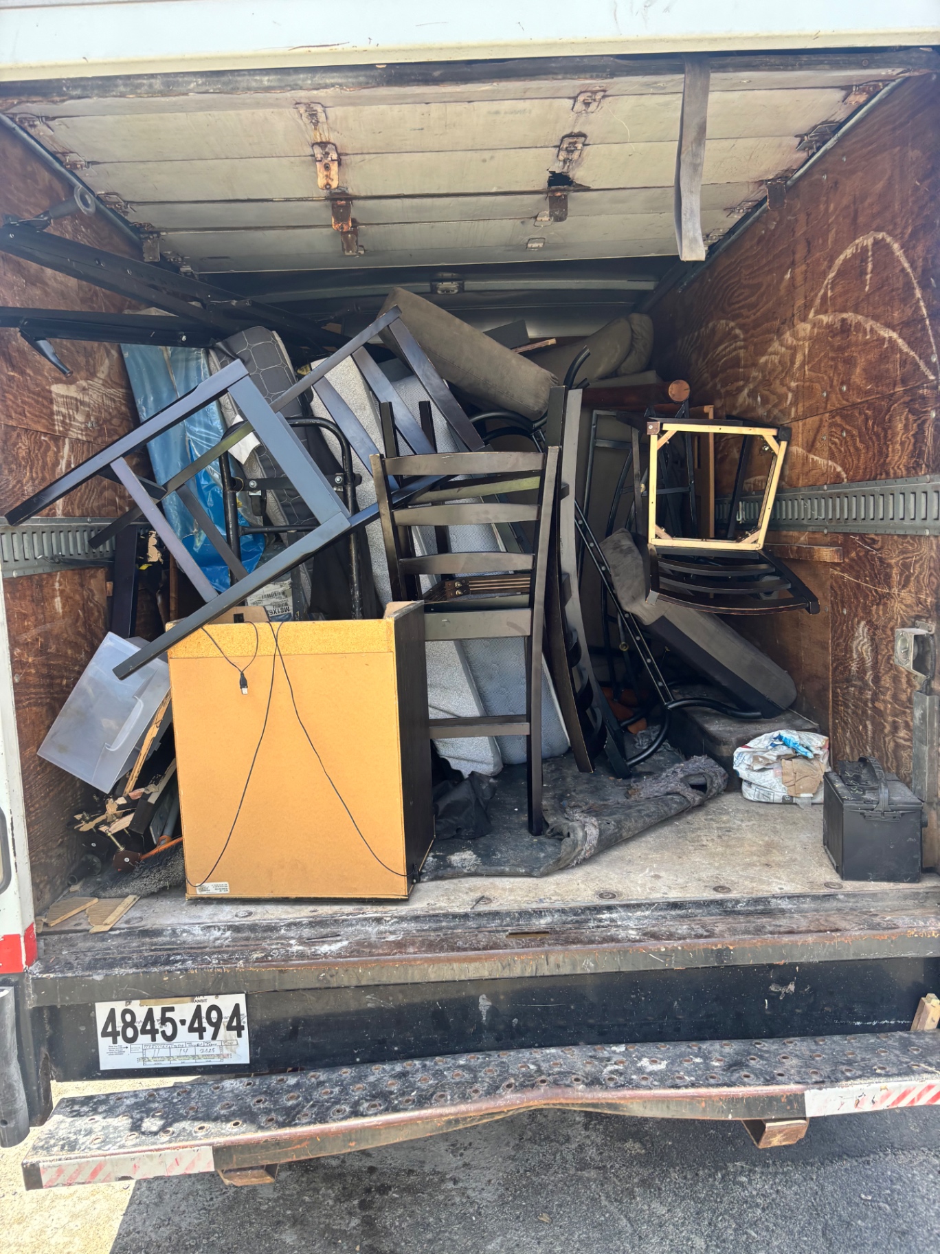 Fully packed B.L.O.O.M. Entity truck loaded with chairs, dressers and furniture after an apartment cleanout
