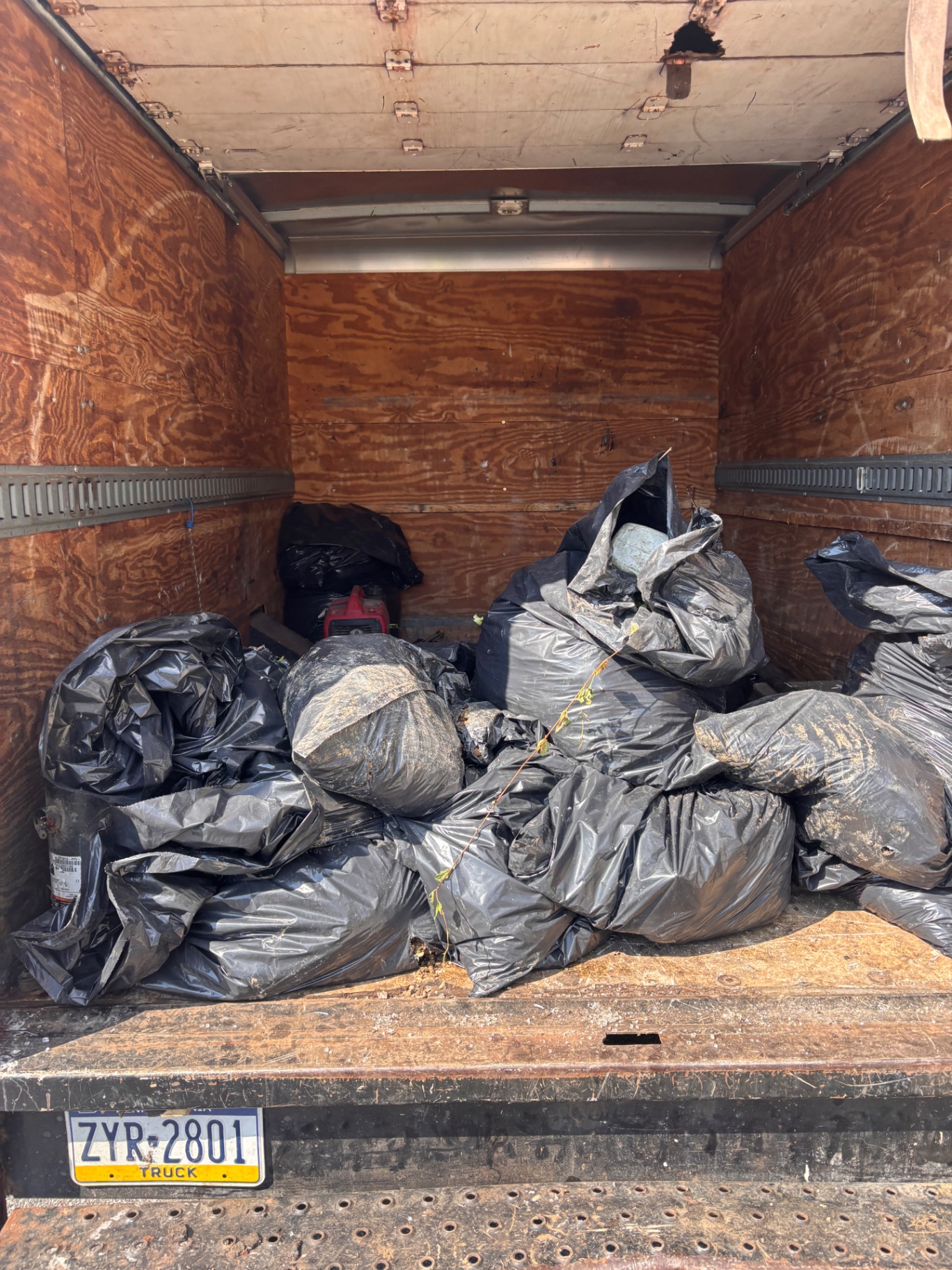 B.L.O.O.M. Entity box truck loaded with bagged construction debris after a full cleanout